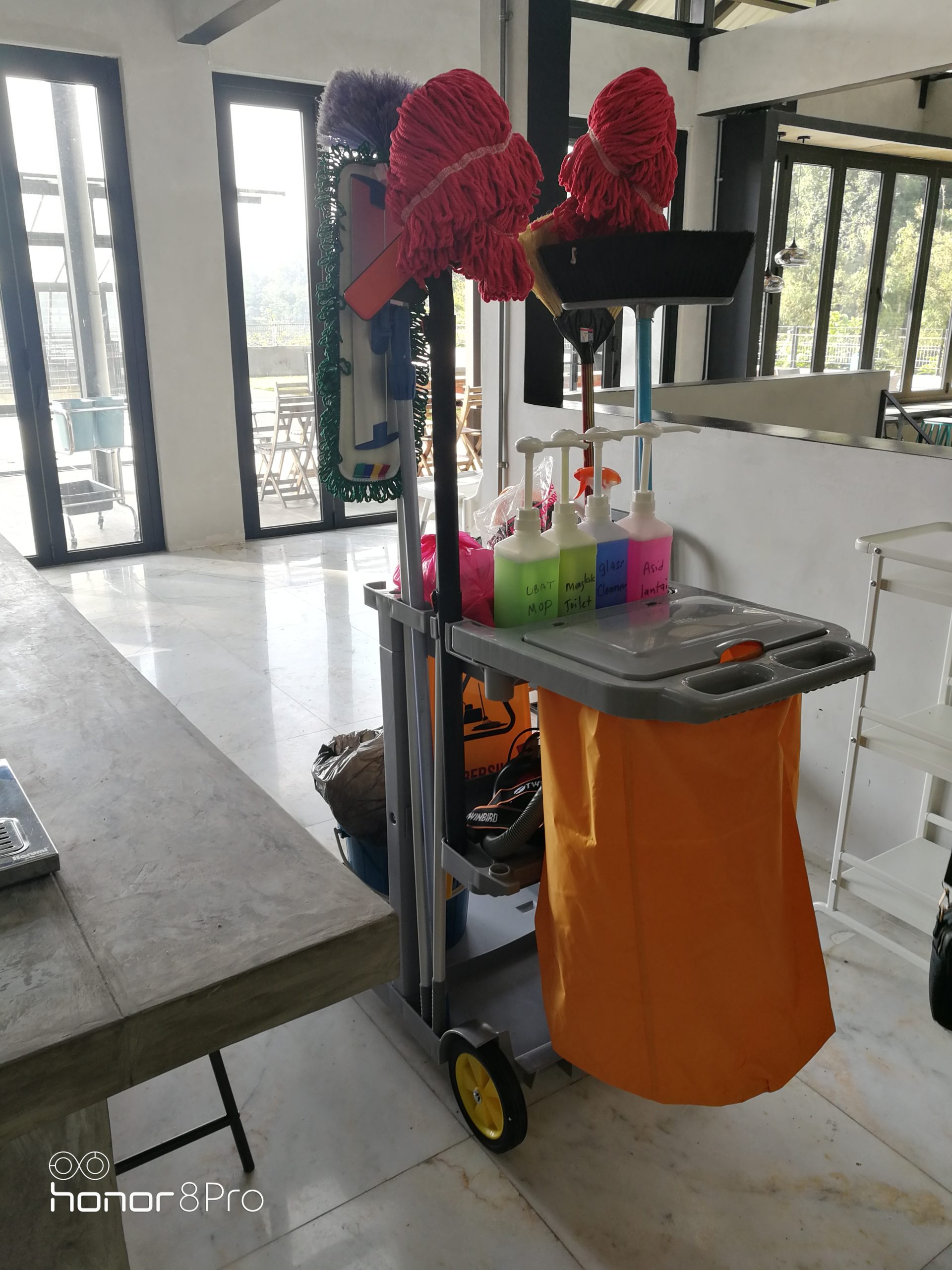 Cleaning trolley with mops and cleaning products at a job site