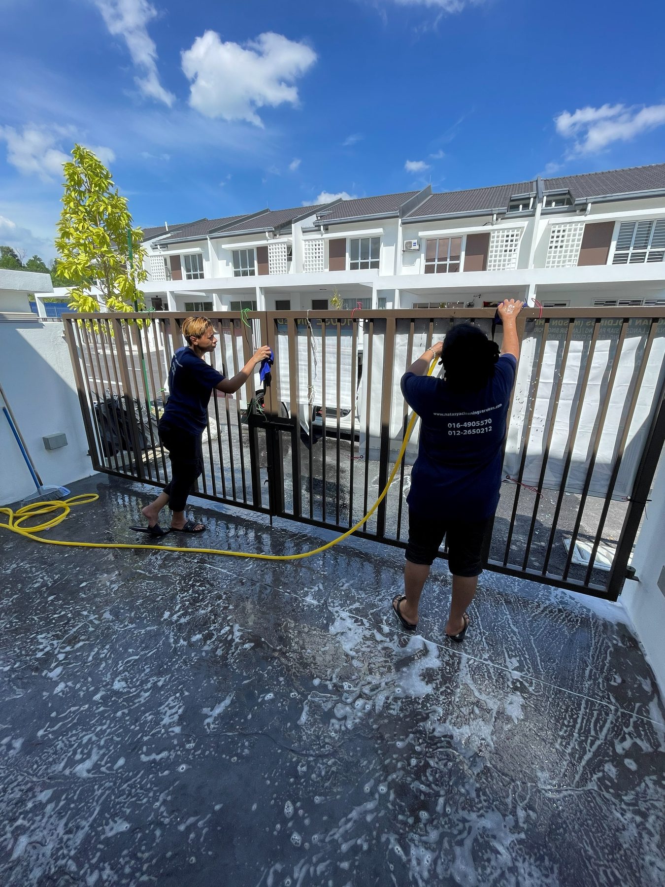 Natasya team washing a residential entrance gate